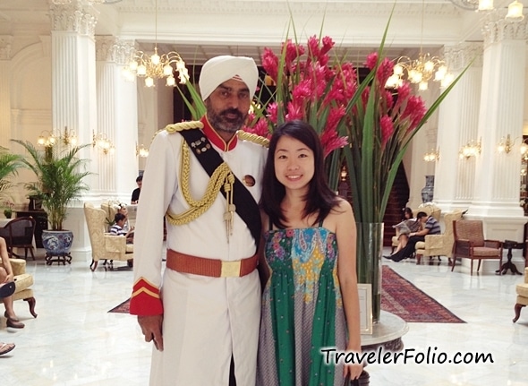 Eunice posing with the doorman at the acclaimed Raffles Hotel in her native Singapore.